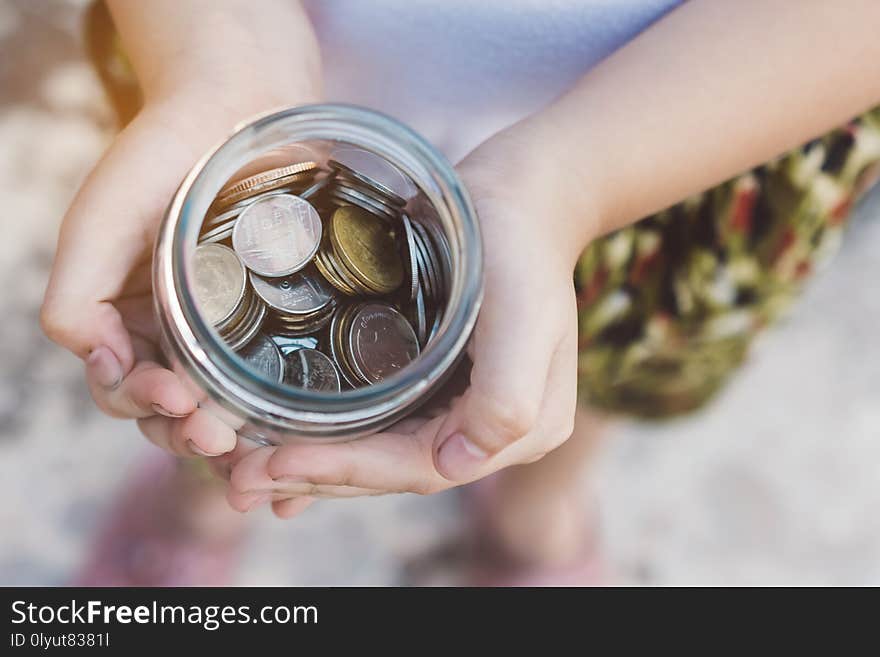 Small kid hands holding coins.