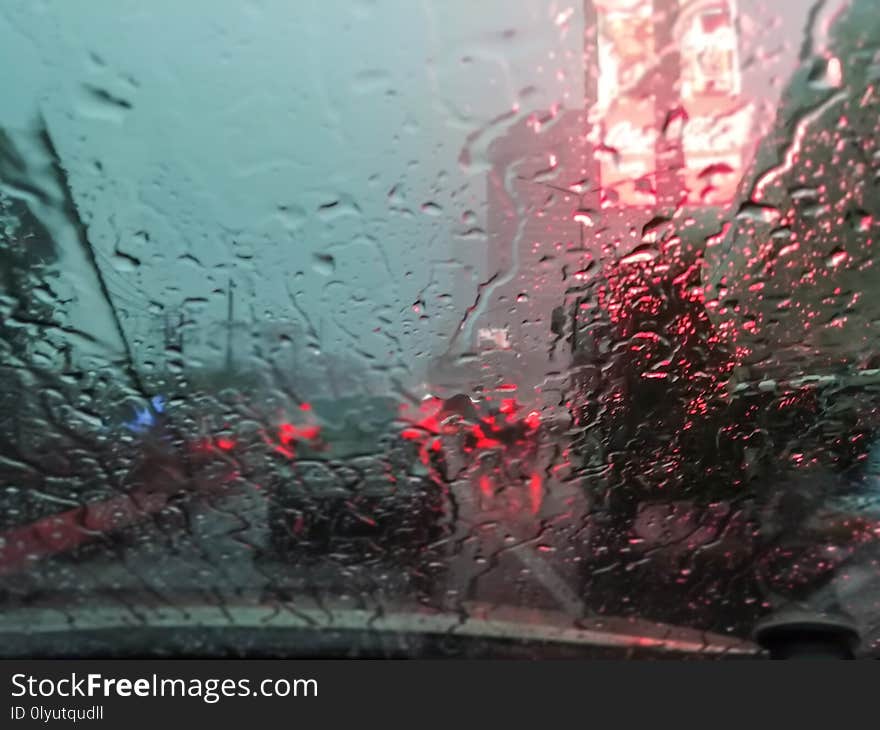Driving through the streets of the city during the storm on the car lot.