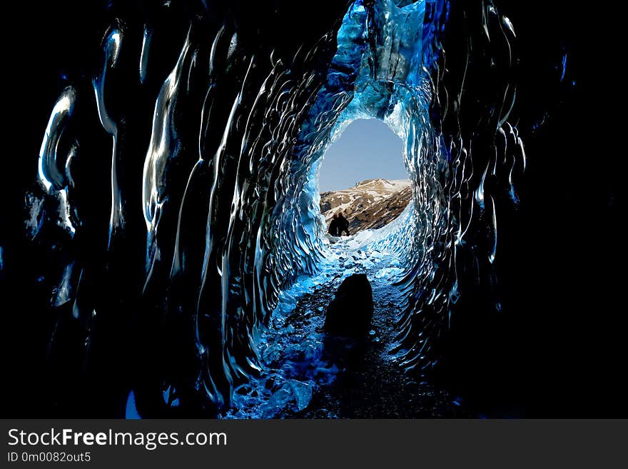 SVINAFELLSJOKULL ICE CAVES looking out to mountains and blue sk