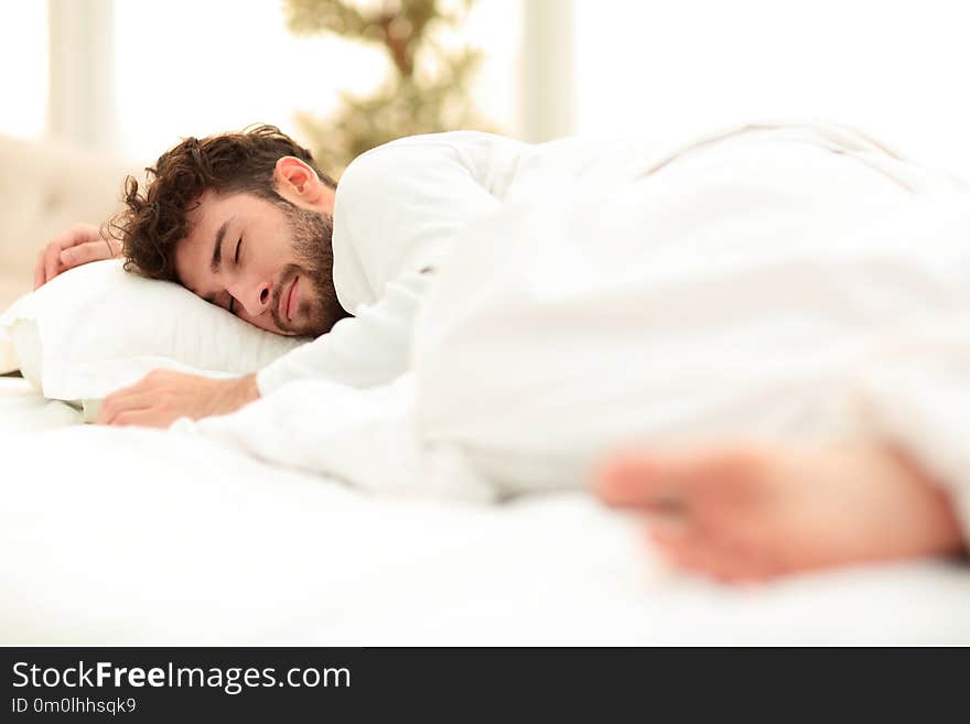 Closeup.the tired men sleep soundly on the bed