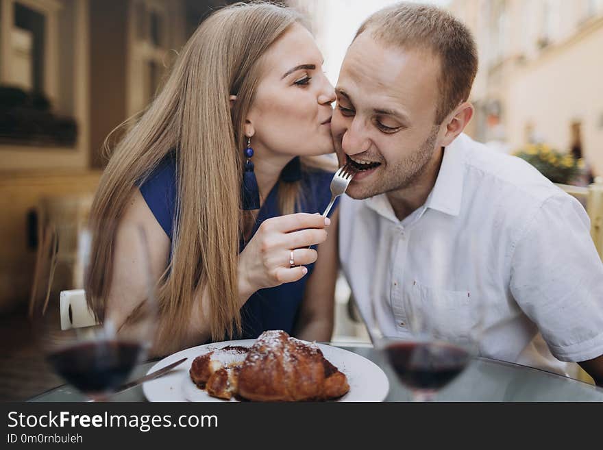 Young couple with glasses of red wine in a restaurant .