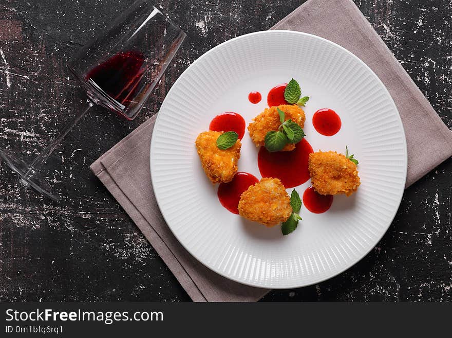 Camembert in batter with strawberry sauce, mint and red wine