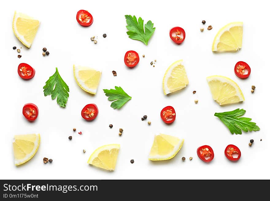 Pattern of lemon pieces and spices on white background, top view. Pattern of lemon pieces and spices on white background, top view