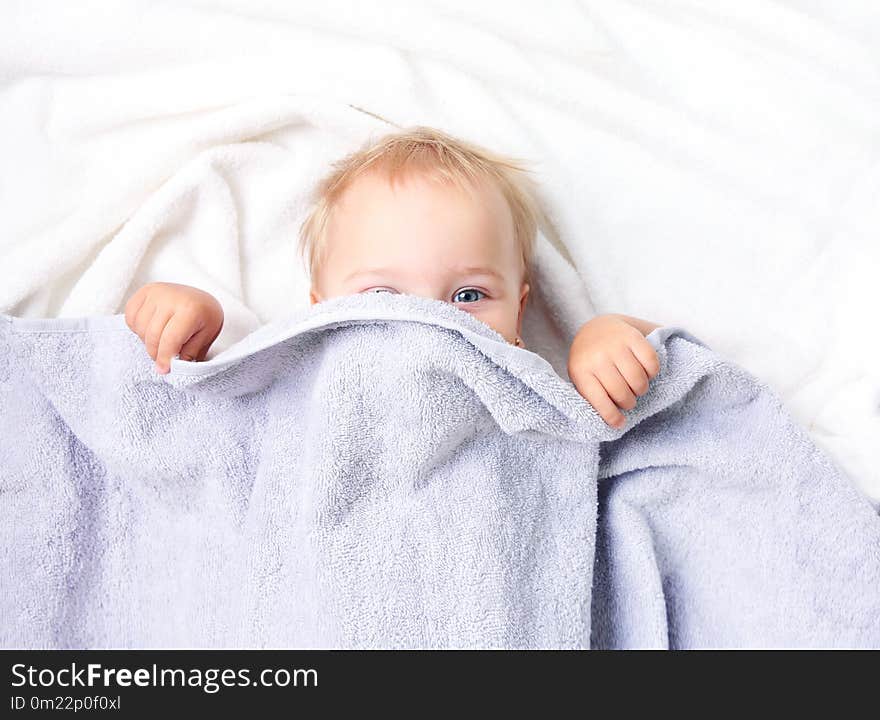 Top view baby child in bed linen covering with blanket.Nursery advertisement design empty copy space. Top view baby child in bed linen covering with blanket.Nursery advertisement design empty copy space.