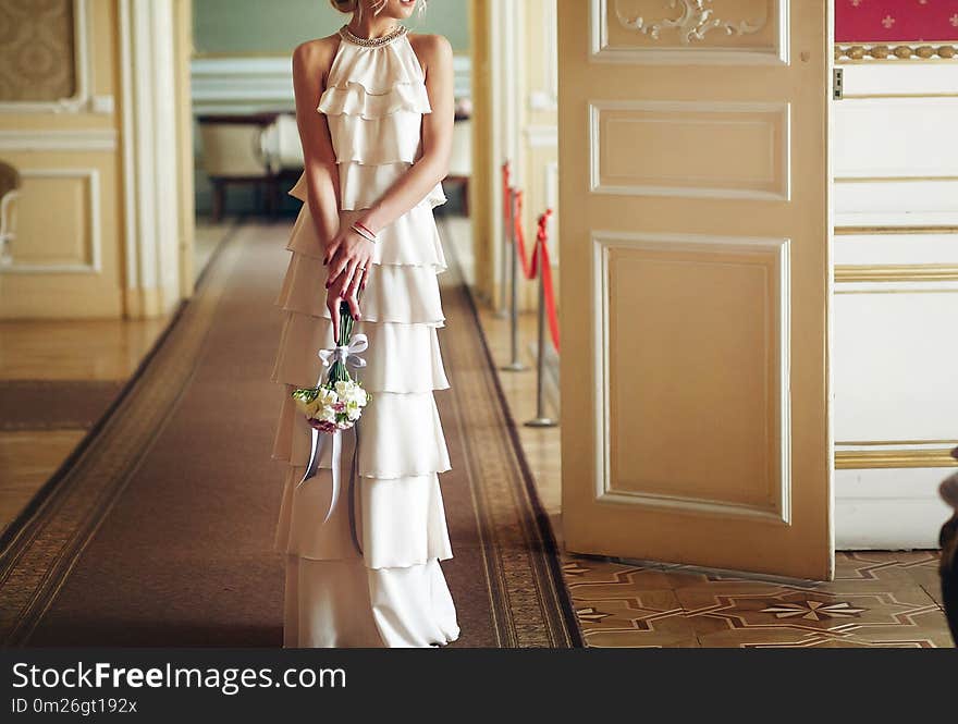 Luxury bride in vintage dress with bouquet posing in luxury hotel room in morning. happy wedding couple, sensual romantic moment in morning