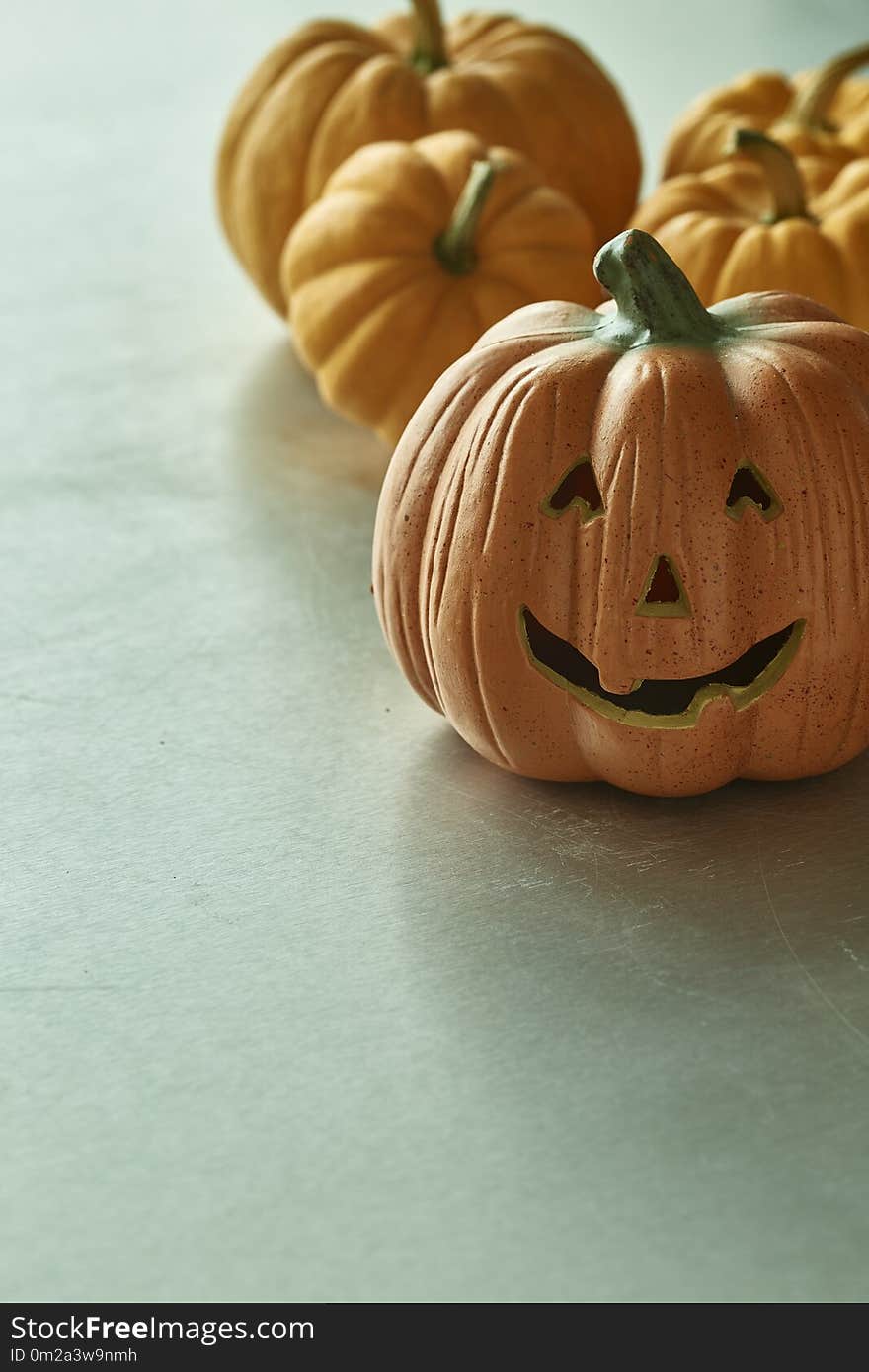 Jack O Lantern And Halloween Pumpkins On Table Back light Nature, copy space. Jack O Lantern And Halloween Pumpkins On Table Back light Nature, copy space