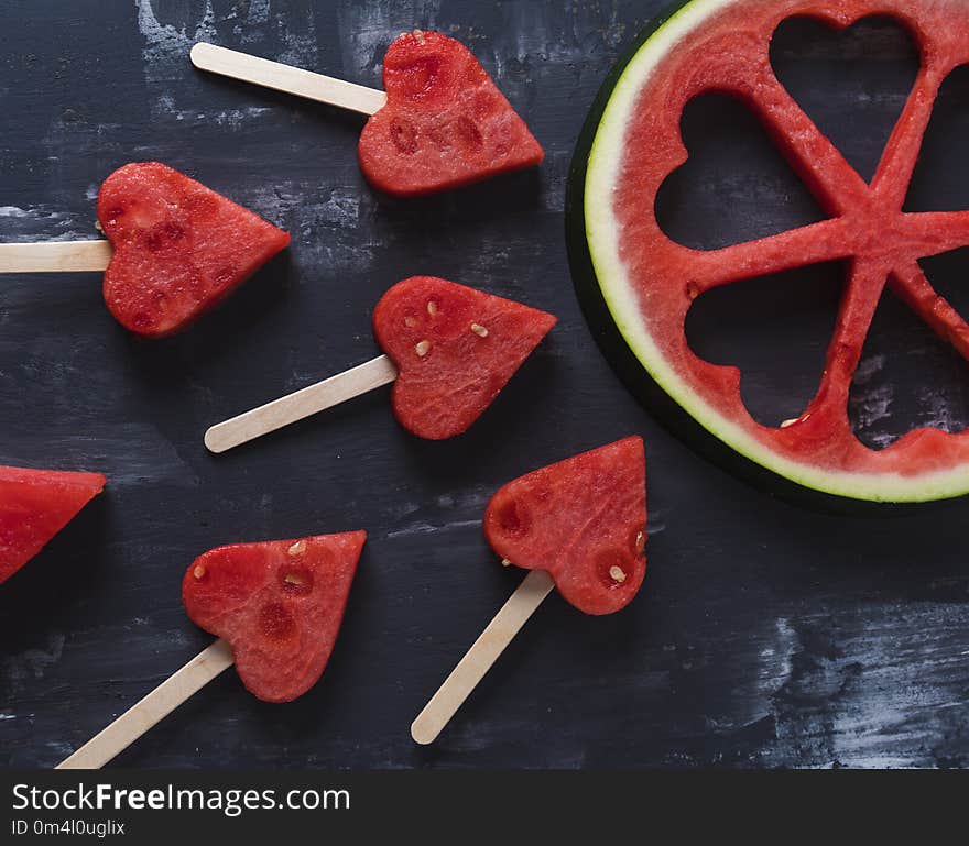 Cute heart pieces of fresh watermelon in black background