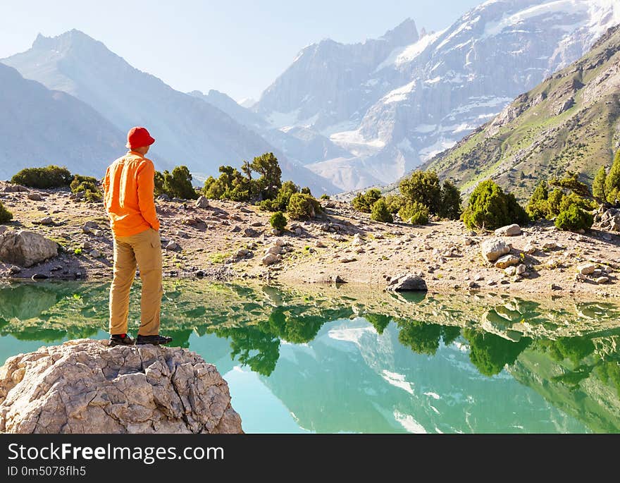 Wanderlust time. Man hiking in beautiful Fann mountains in Pamir, Tajikistan. Central Asia. Wanderlust time. Man hiking in beautiful Fann mountains in Pamir, Tajikistan. Central Asia.