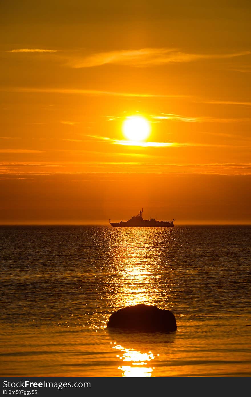 Wonderful landscape with a ship in the sea at sunset