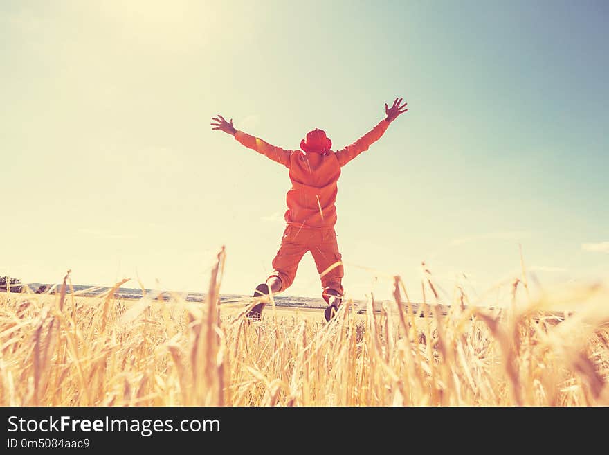 Happy man in yellow wheat field