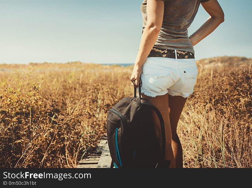 Unrecognizable girl traveler with a backpack In Summer, Rear Vie