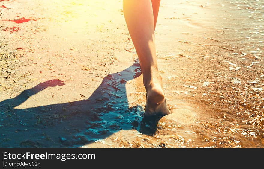 Freedom and Happiness Travel Adventure Scout Concept. Unrecognizable girl is walking along the beach in summer day