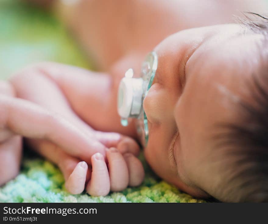 Cute tiny kid napping peacefully while mother hugging him . Lifestyle, family concept. Cute tiny kid napping peacefully while mother hugging him . Lifestyle, family concept.