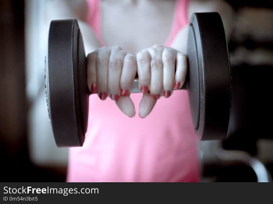 Girl doing exercise with 4 kg weights in the gym. Girl doing exercise with 4 kg weights in the gym