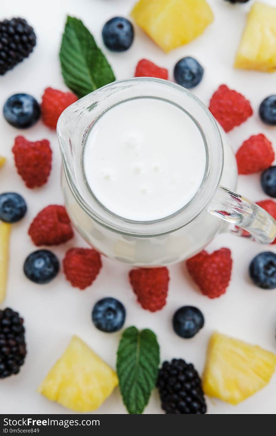 Ingredients for smoothies with berries, pineapple and raspberry