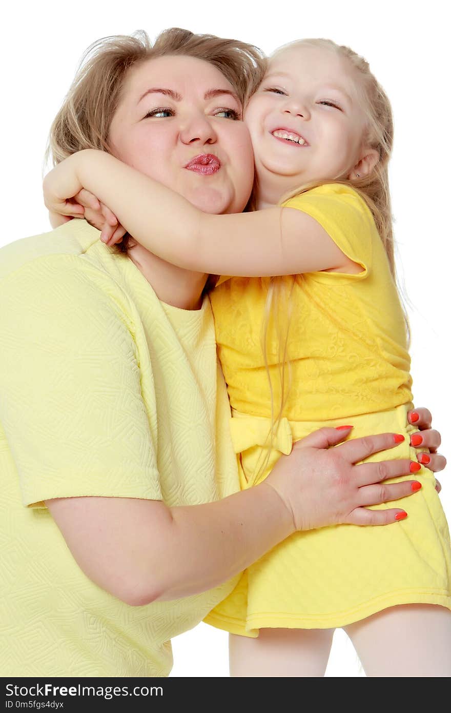 Mom and little daughter plus the size of the model, gently embrace. A women and her daughter are smiling in a happy manner. Good for the concept of health, happiness, diet, obesity, weight loss.