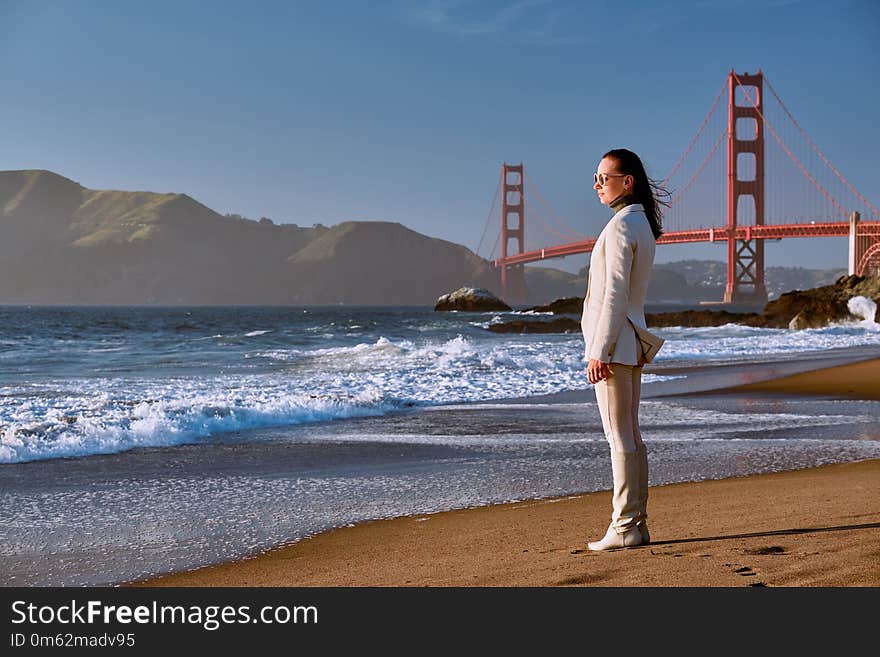 Woman on beach near Golden Gate Bridge