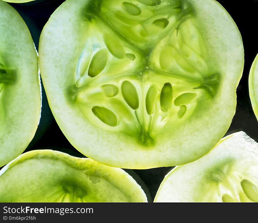 Macro Photo Of An Illuminated Lemon Cucumber Slice.