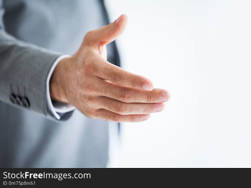 businessman extending hand to shake on white background