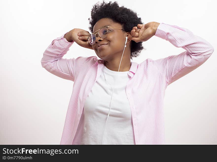 Sleepy cheerful black woman waking up with music