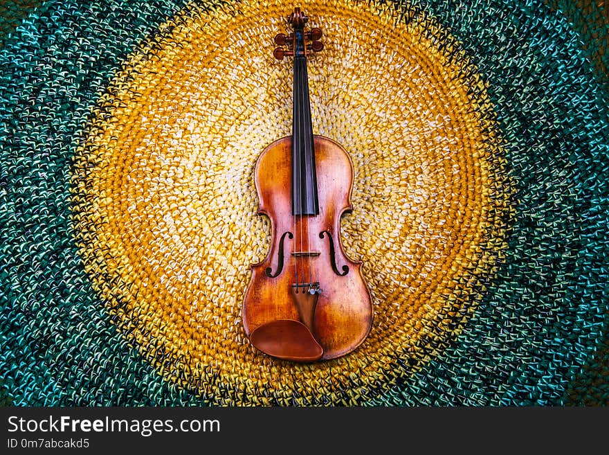 violin on a colored knitted rug