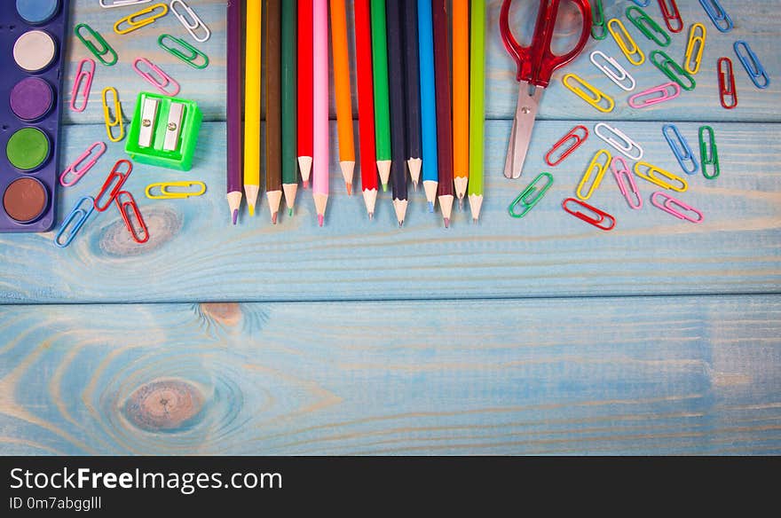 School supplies on a blue wooden background. A place for an inscription. Back to school. School supplies on a blue wooden background. A place for an inscription. Back to school.