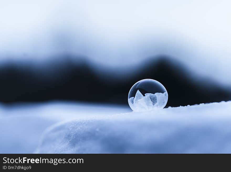 Frozen round soap bubble on snow