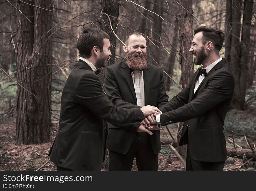 Business partners standing with folded hands together