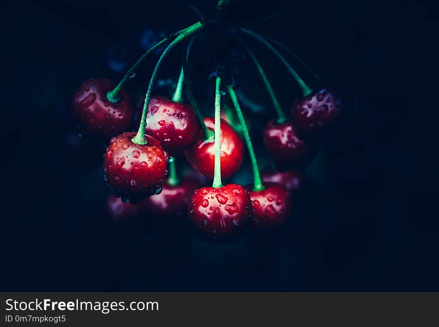 Red cherries on the dark black background. Healthy seasonal fruits. Red cherries on the dark black background. Healthy seasonal fruits.