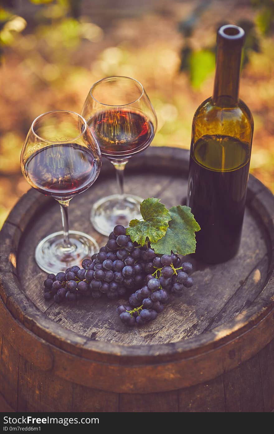 Top view of two glasses of red wine on a wooden barrel