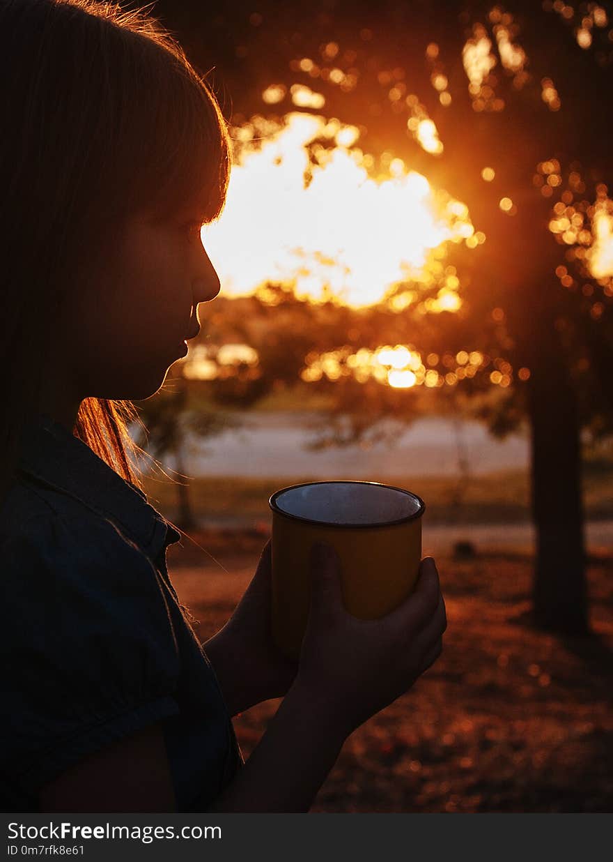 Cute little girl with a cup in autumn park. Cute little girl with a cup in autumn park.