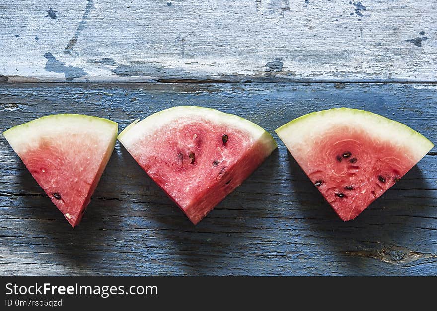 slices of watermelon on rustic wooden background, top view. slices of watermelon on rustic wooden background, top view