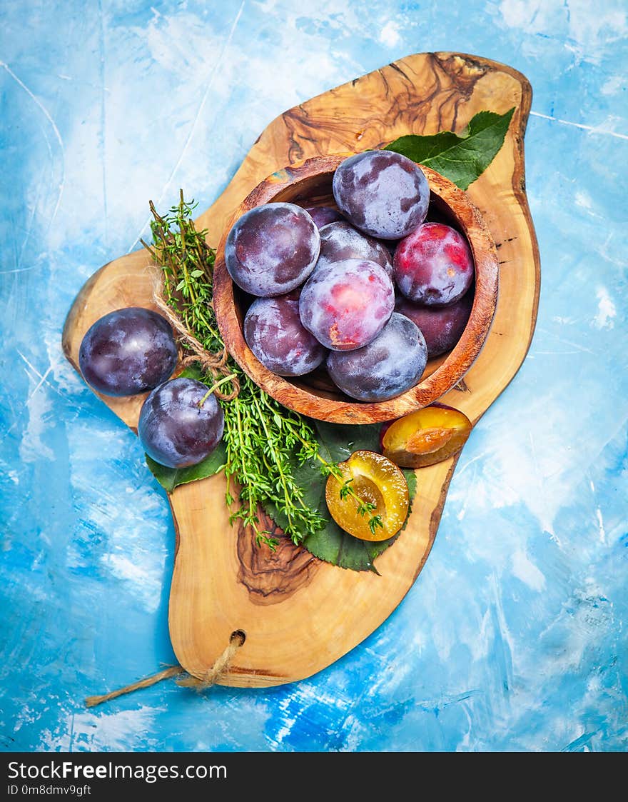 Plums on wooden table close-up. Healthy diet