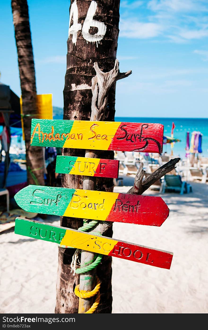 Phuket colourful beach sign at Patong beach, summer tropical island white sand beach with sign and coconut tree, Thailand