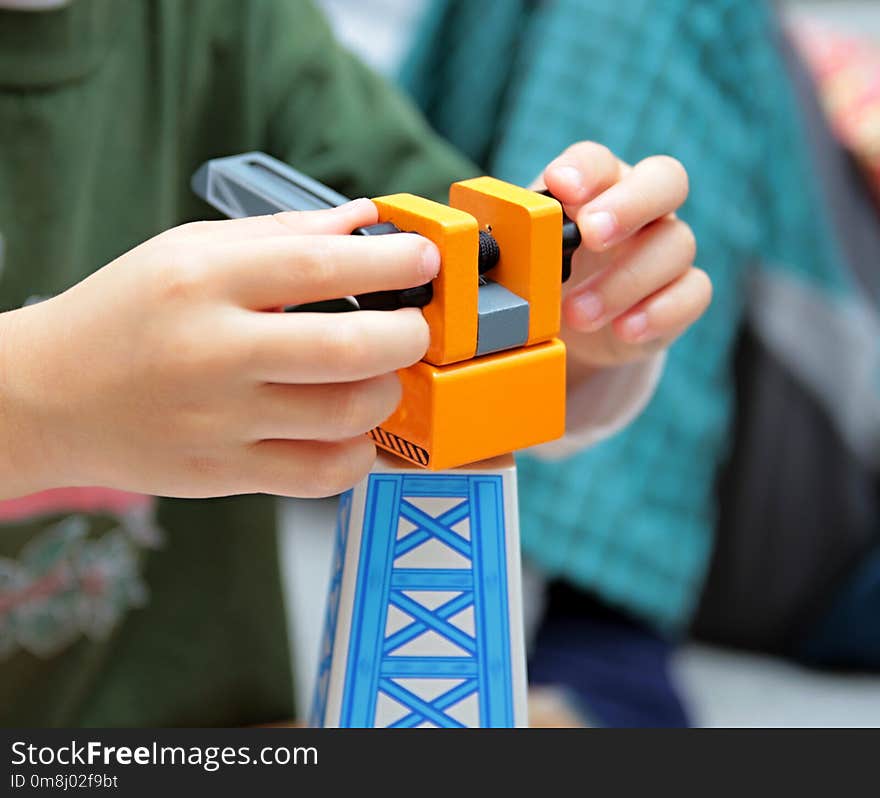 Child playing with toy crane