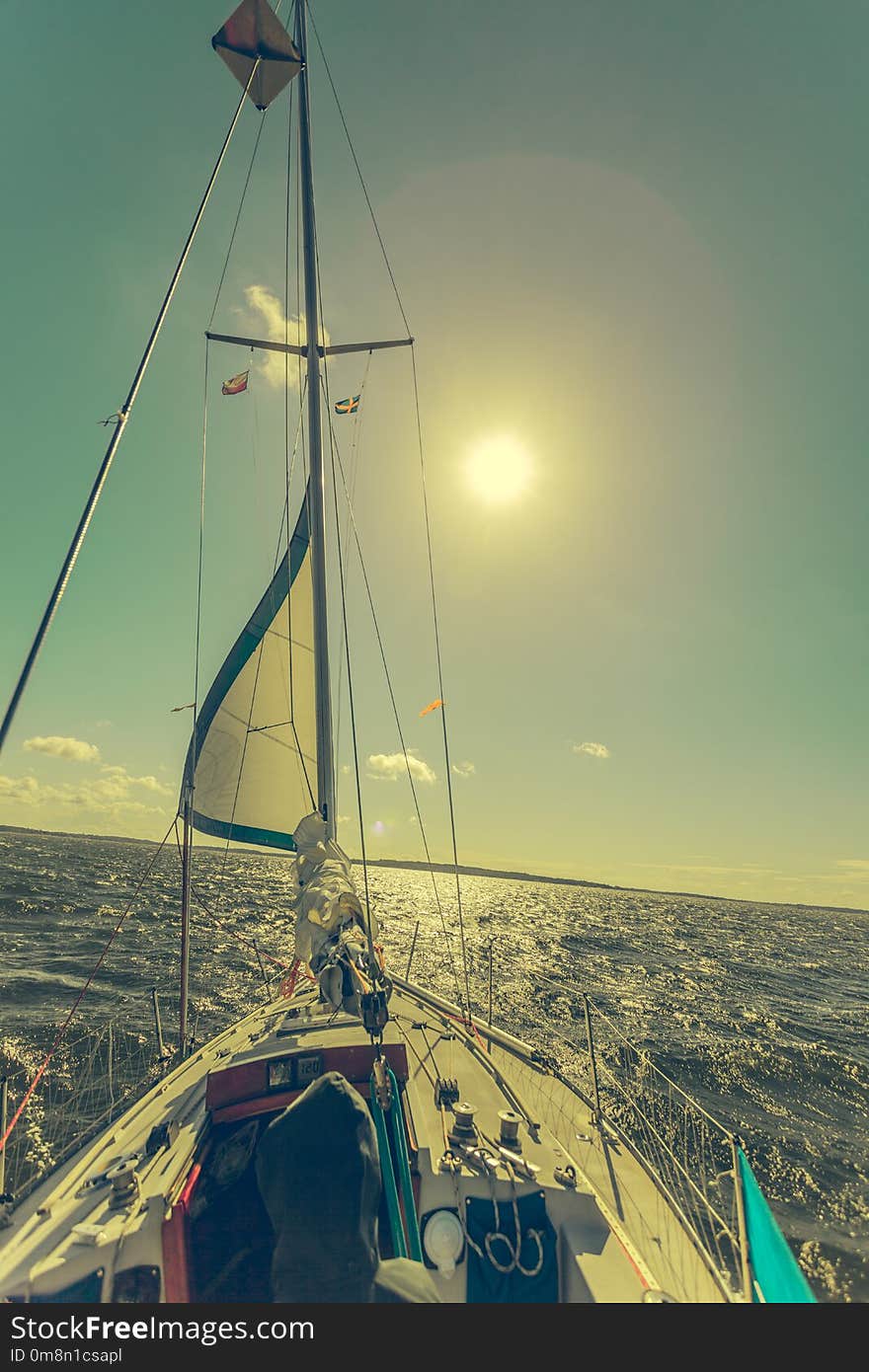 Yachting on sail boat during sunny summer weather on calm blue sea water. Sporty transportation conept. Yachting on sail boat during sunny summer weather on calm blue sea water. Sporty transportation conept.