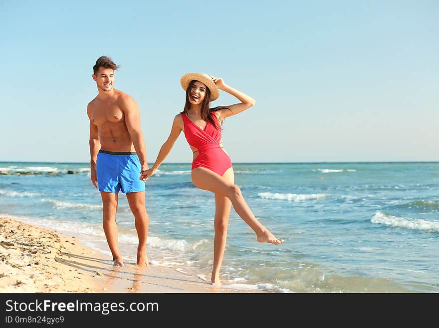 Happy young couple having fun at beach