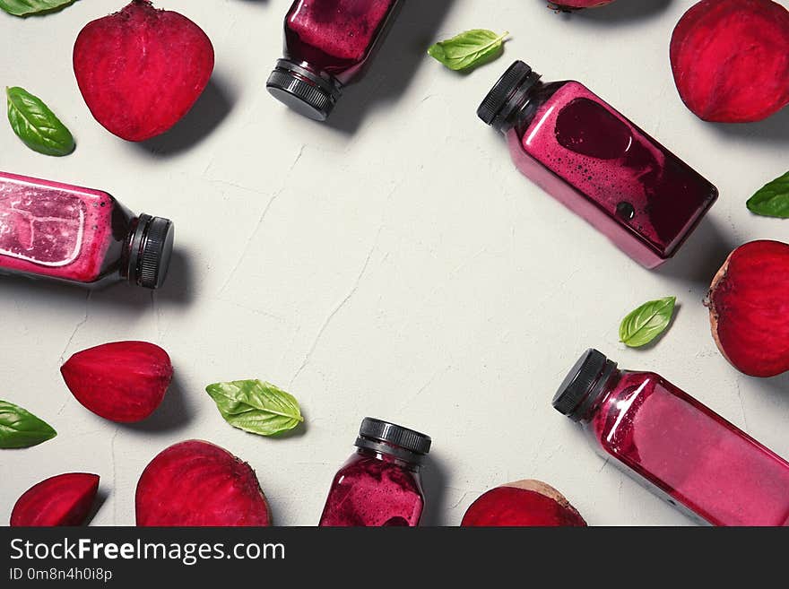 Flat lay composition with beet smoothies on light background. Space for text