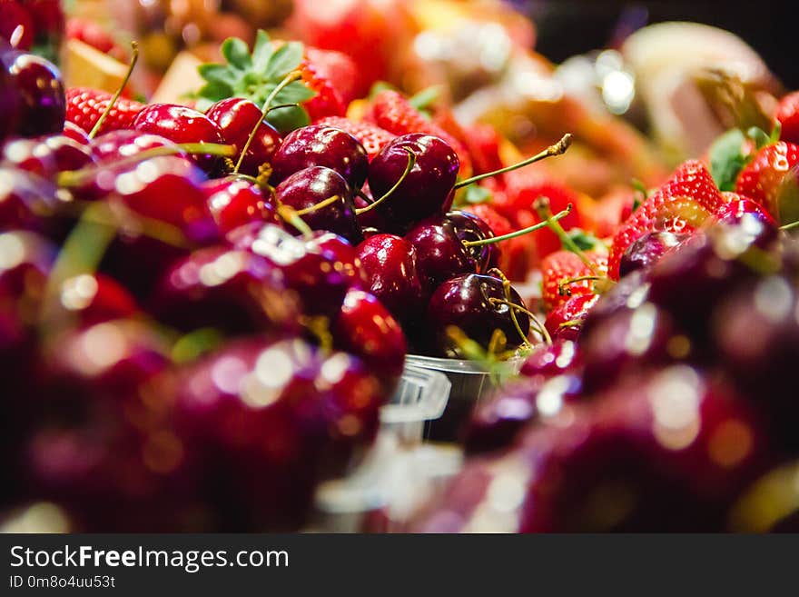 Fcherries and strawberries ruit in a market in barcelona spain