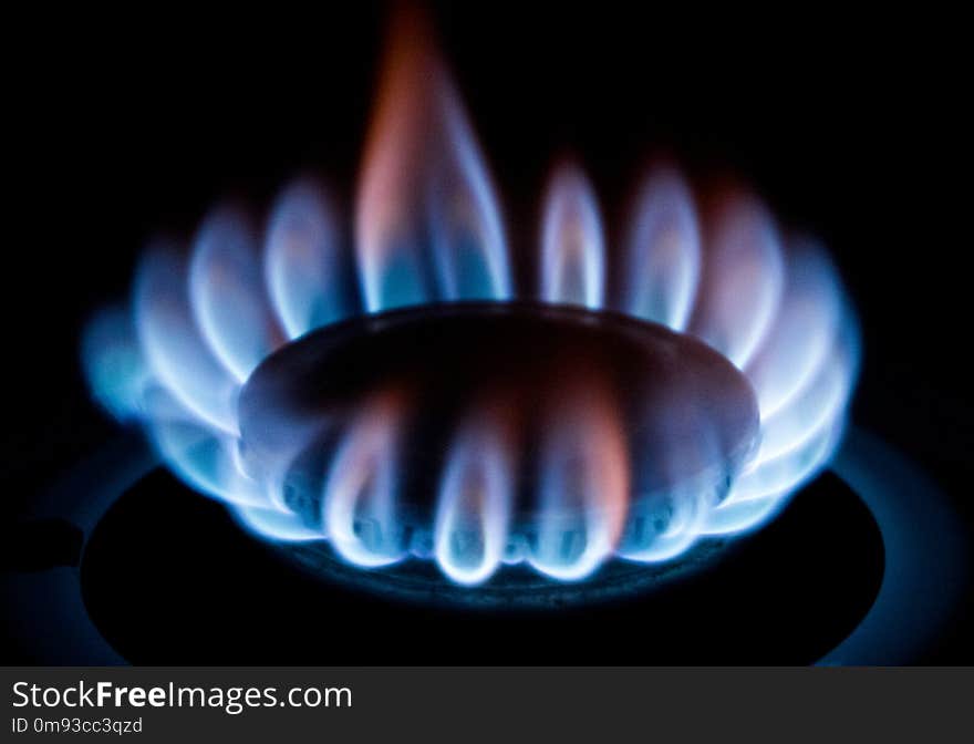 A blue flame emits from a gas cooker. A blue flame emits from a gas cooker.