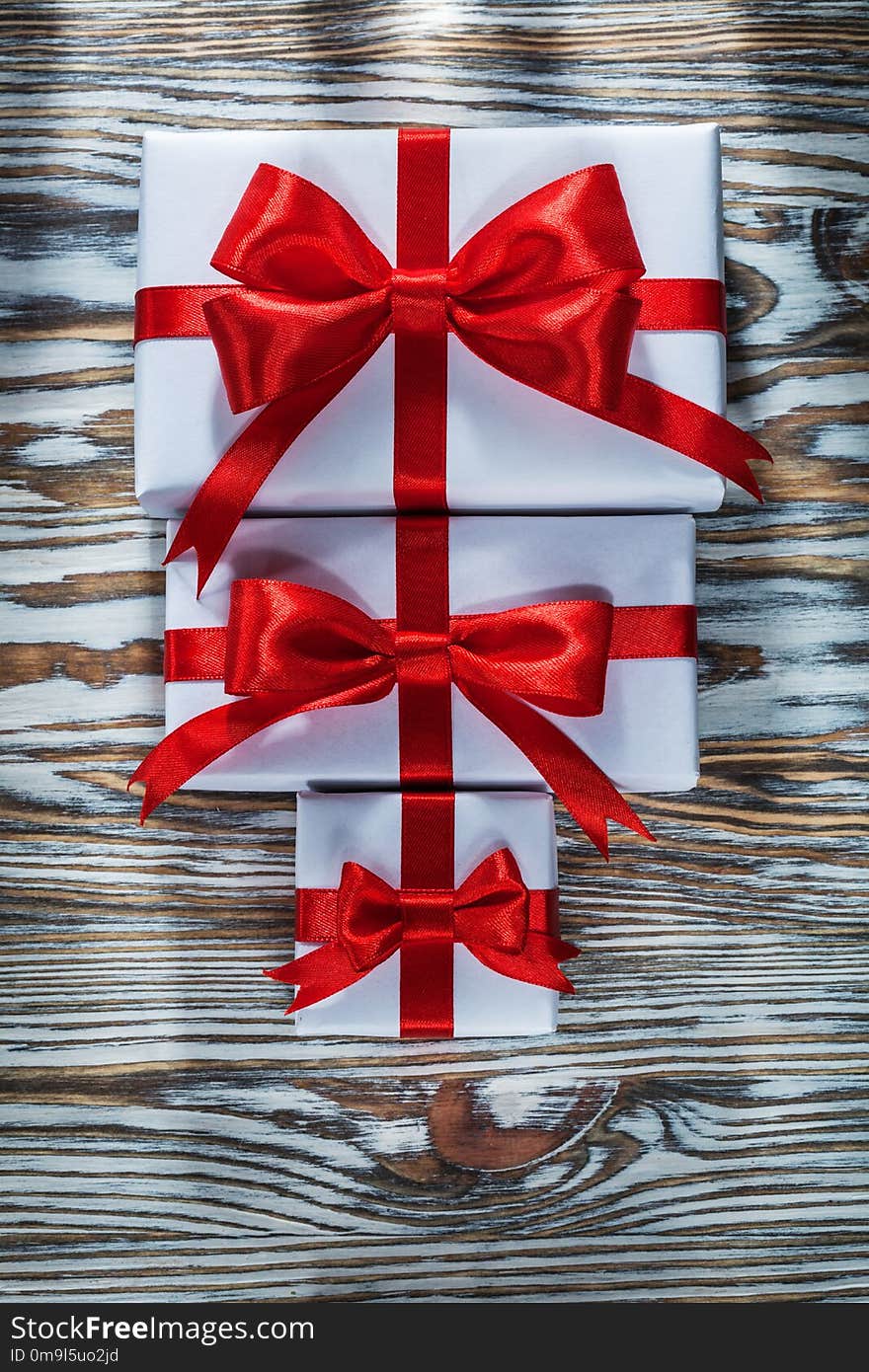 Set of red packed gift boxes on wooden surface