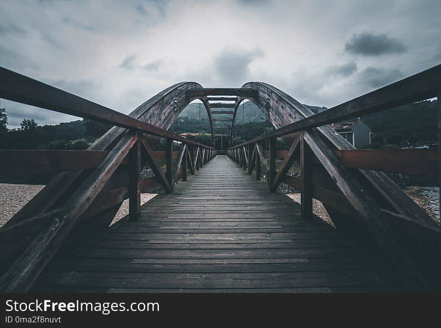 The wooden bridge. Bridge collapse. Bridge across the river. Cloudy sky. The wooden bridge. Bridge collapse. Bridge across the river. Cloudy sky