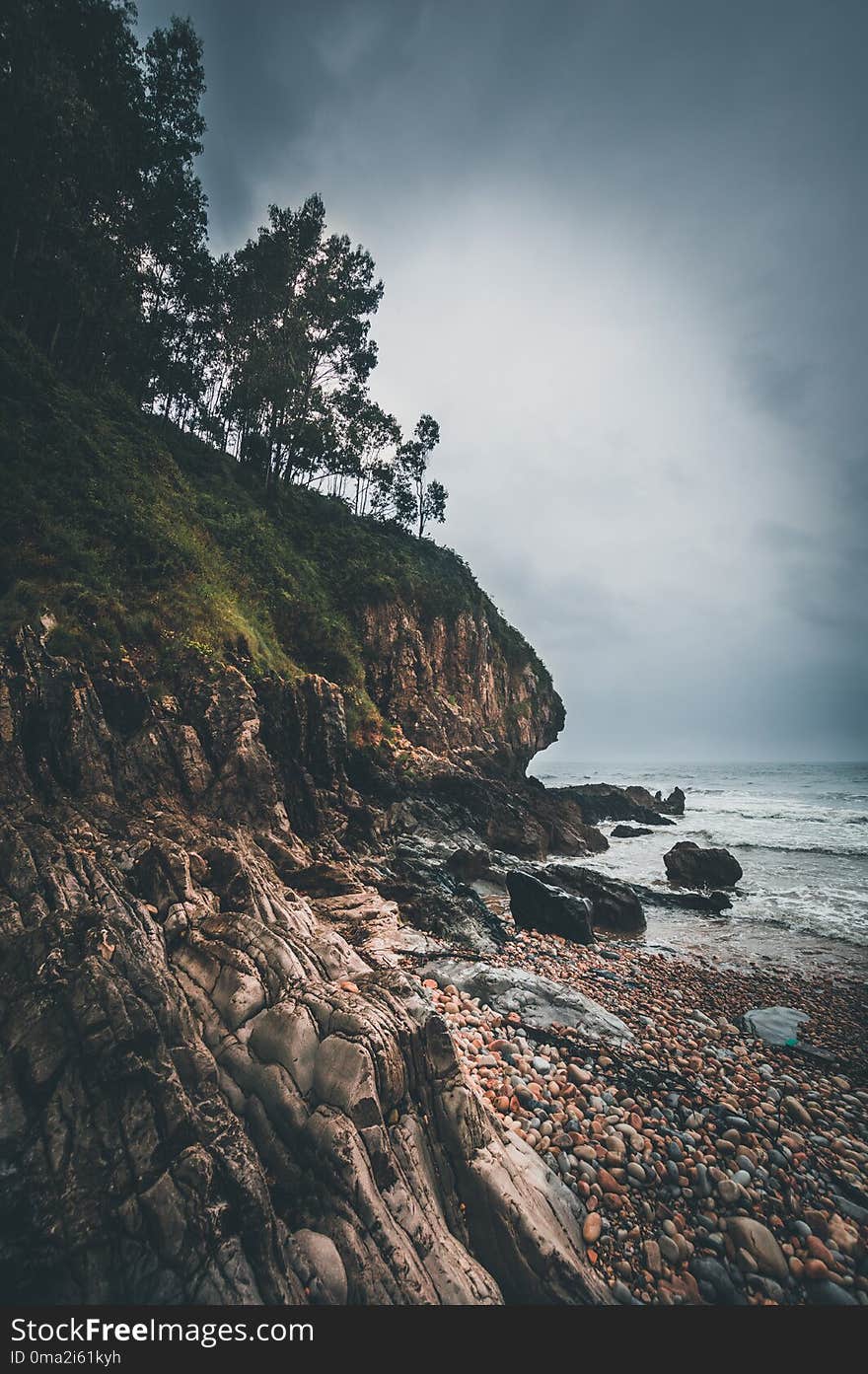 Beach with rocks and cloudy day