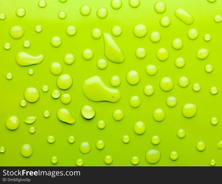 Macro of water drops on green surface