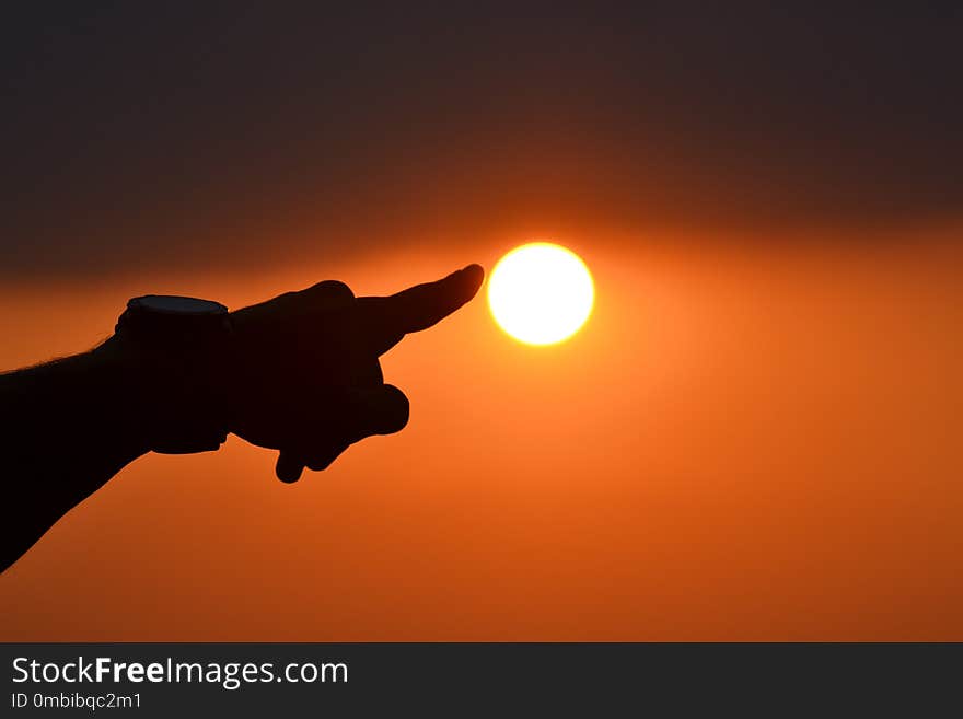 Man try to touch the sun. sunset in Serbia. Summer time. Man try to touch the sun. sunset in Serbia. Summer time