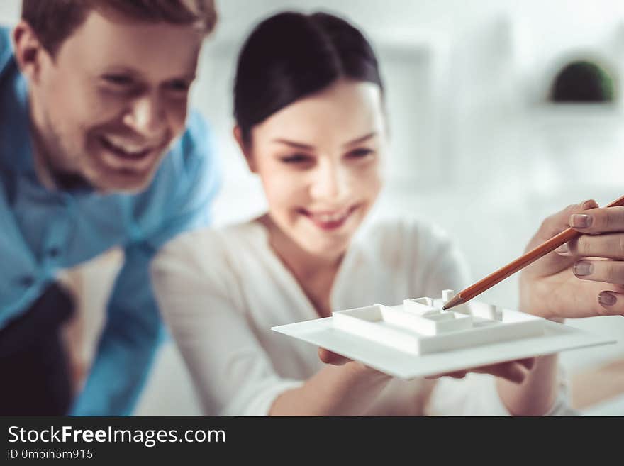 High spirits. Amazing female person keeping smile on her face while examining model of settlement. High spirits. Amazing female person keeping smile on her face while examining model of settlement