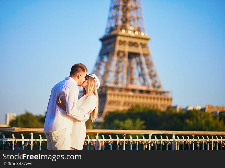 Romantic couple having a date near the Eiffel tower. Tourists in Paris enjoying the city