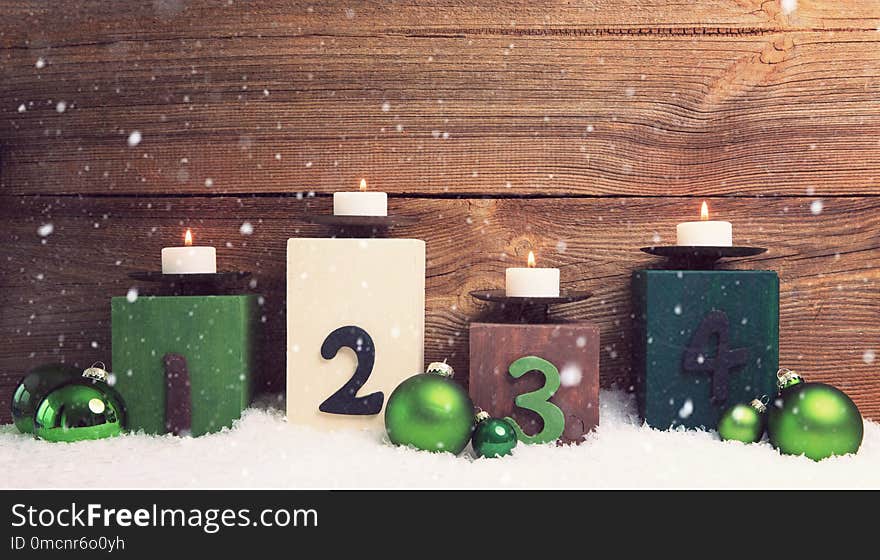 Four candles decorated with christmas balls burning , concepts for fourth advent