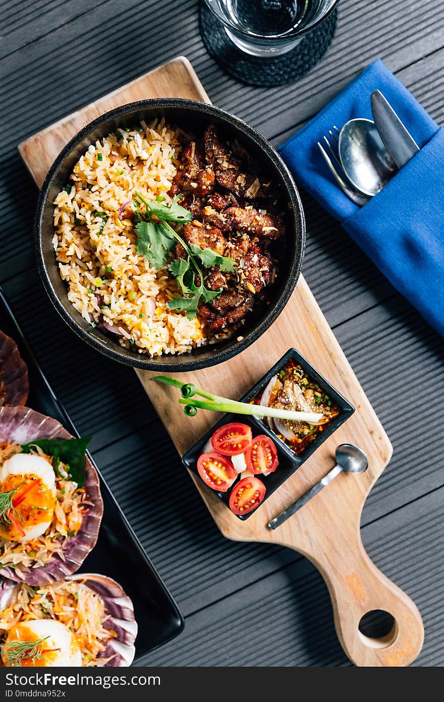 Top view of Thai style grilled pork fried rice served with Thai spicy dipping sauce.