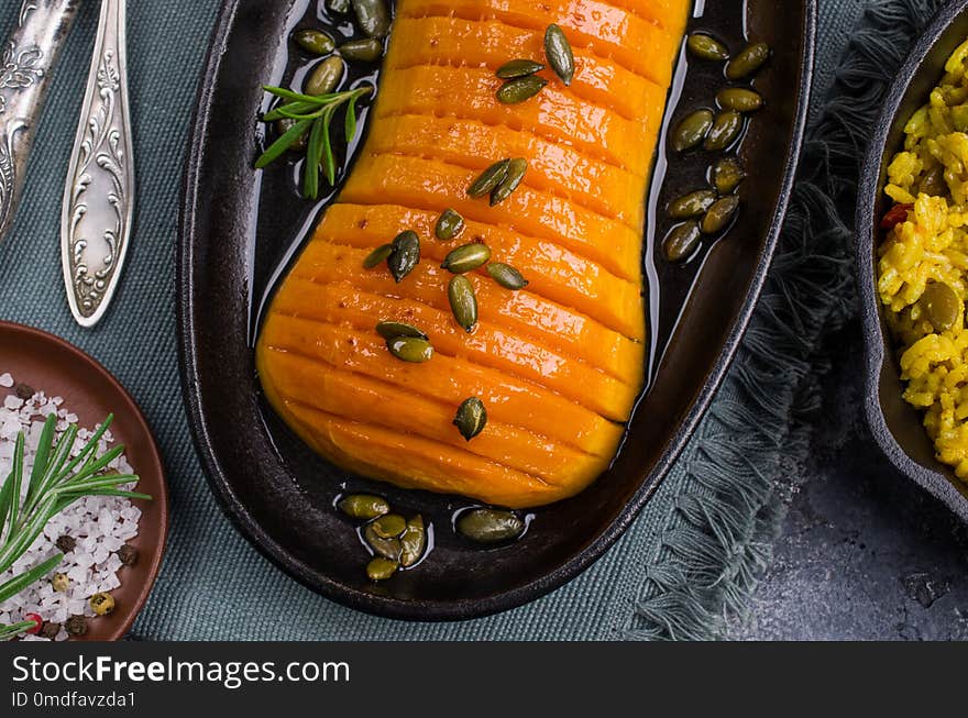 Roasted Butternut squash with spicy rice in a dish on the table. Selective focus.